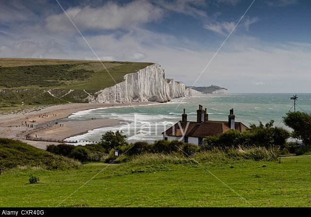 Coast Guard cottages in front of the Seven Sisters chalk cliffs at Cuckmere Haven, East Sussex, England